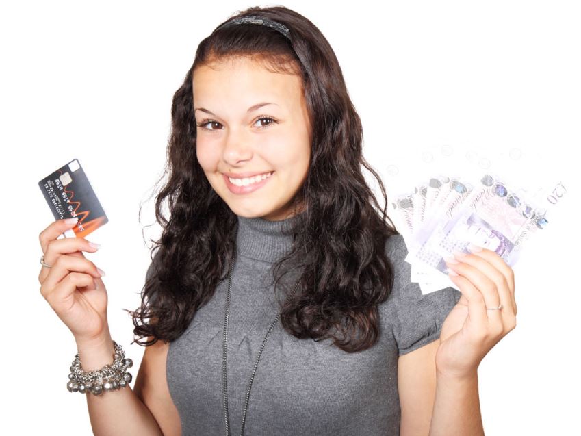 girl holding a credit card and cash